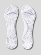 Transparent gel insole with heel cup and arch support placed inside a blue suede stiletto heel