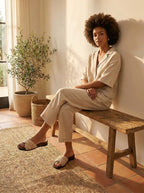 Model wearing Woven raffia flat slides with cognac suede footbed and square toe Belvarnè Tressa