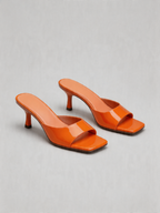 Patent curved heel mule square open toe tangerine orange top view women's
Patent curved heel mule square open toe tangerine orange side view women's
Patent curved heel mule square open toe tangerine orange heel detail women's
